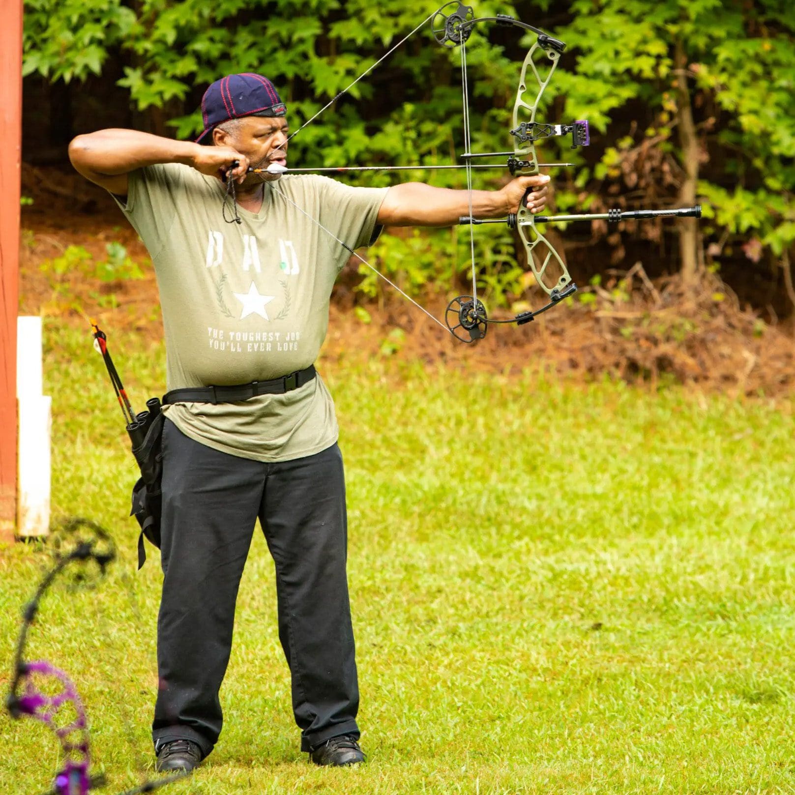 Female veteran shoots bow at archery